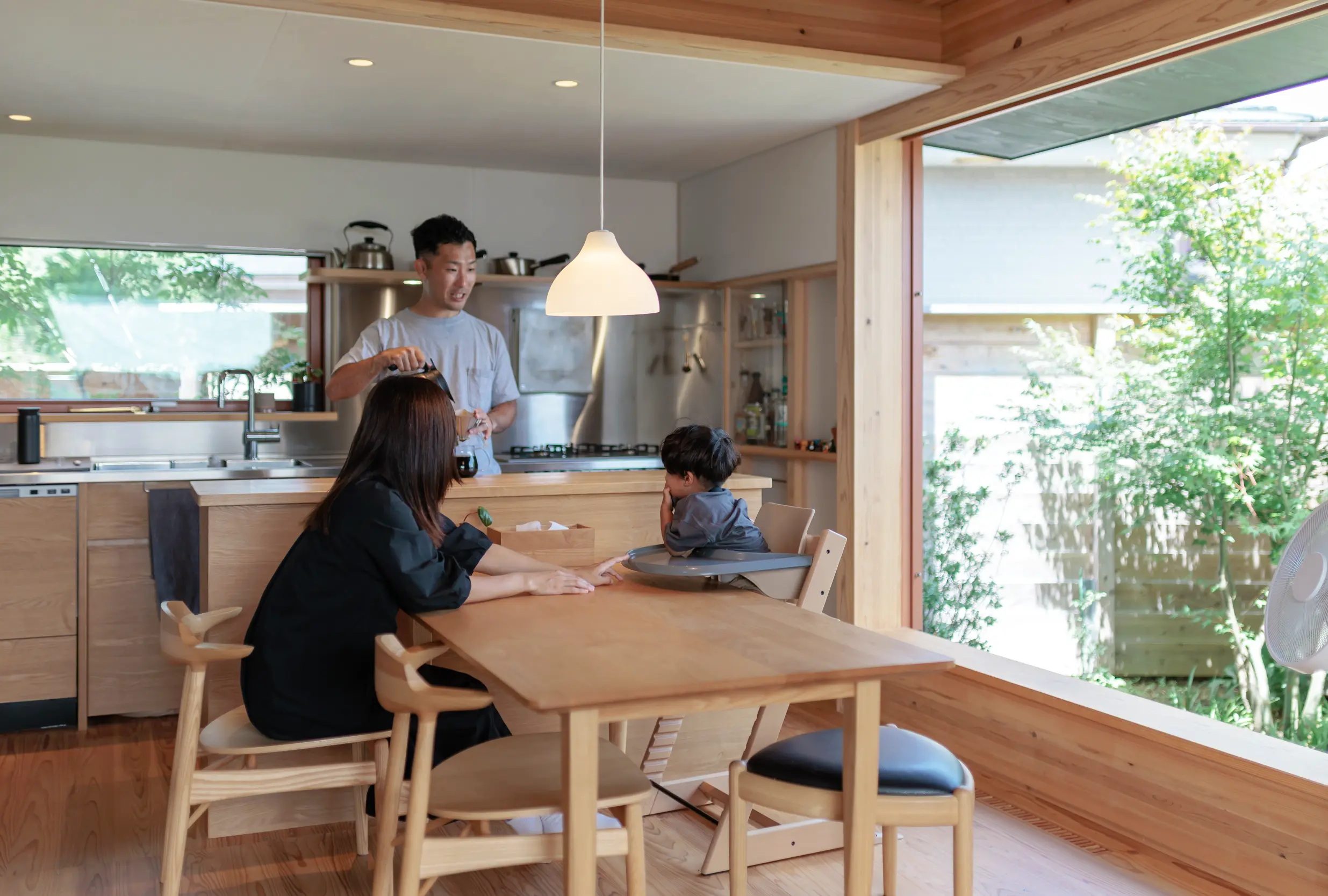 大きな窓で外とつながるダイニングキッチンはいつも緑を感じられる居場所。居心地の良さに家族がしぜんと集まります。